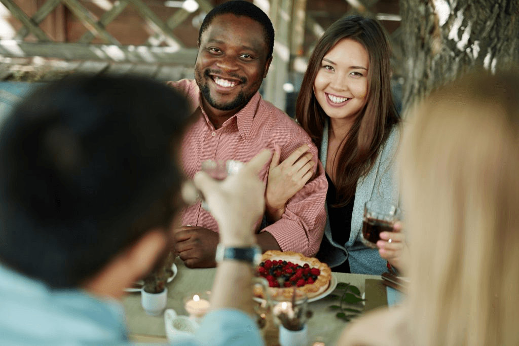 A happy couple connecting at a warm Zenzephyr dinner