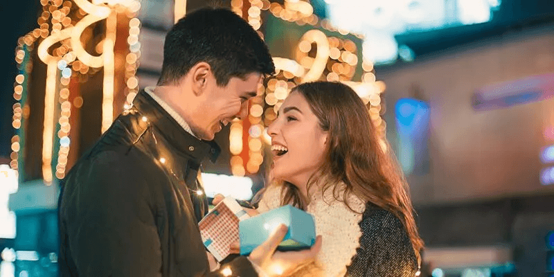 A couple sharing a warm, intentional moment together on a festive evening